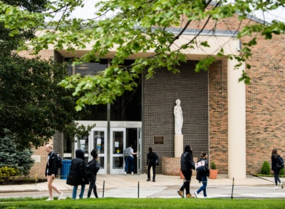 People walking in front of a campus building