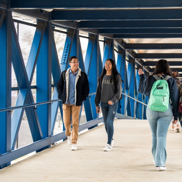Students walking across a bridge tunnel