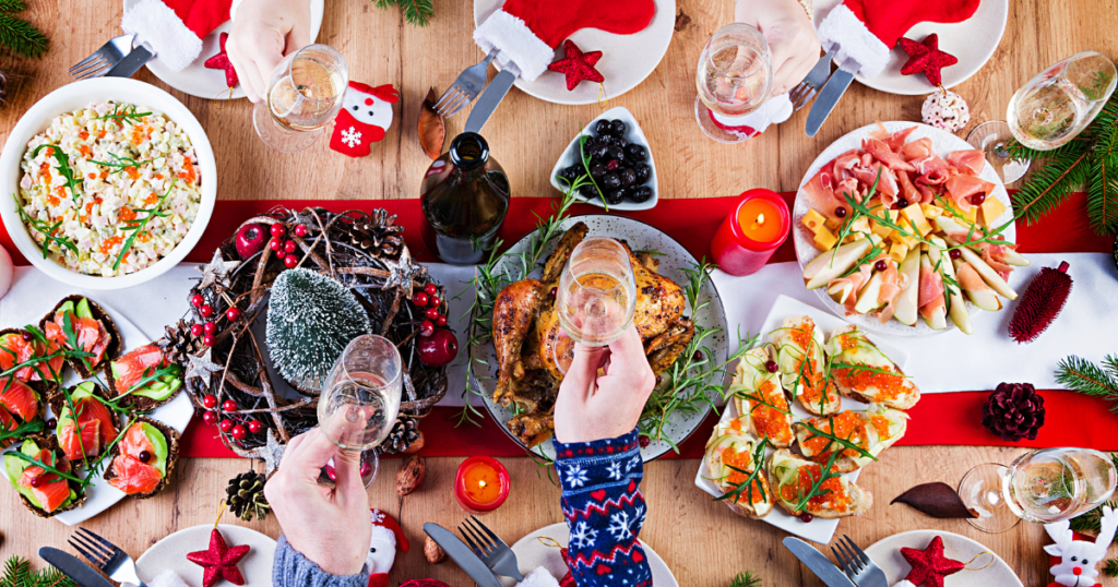 Image of people holding their champagne glasses over a holiday meal.