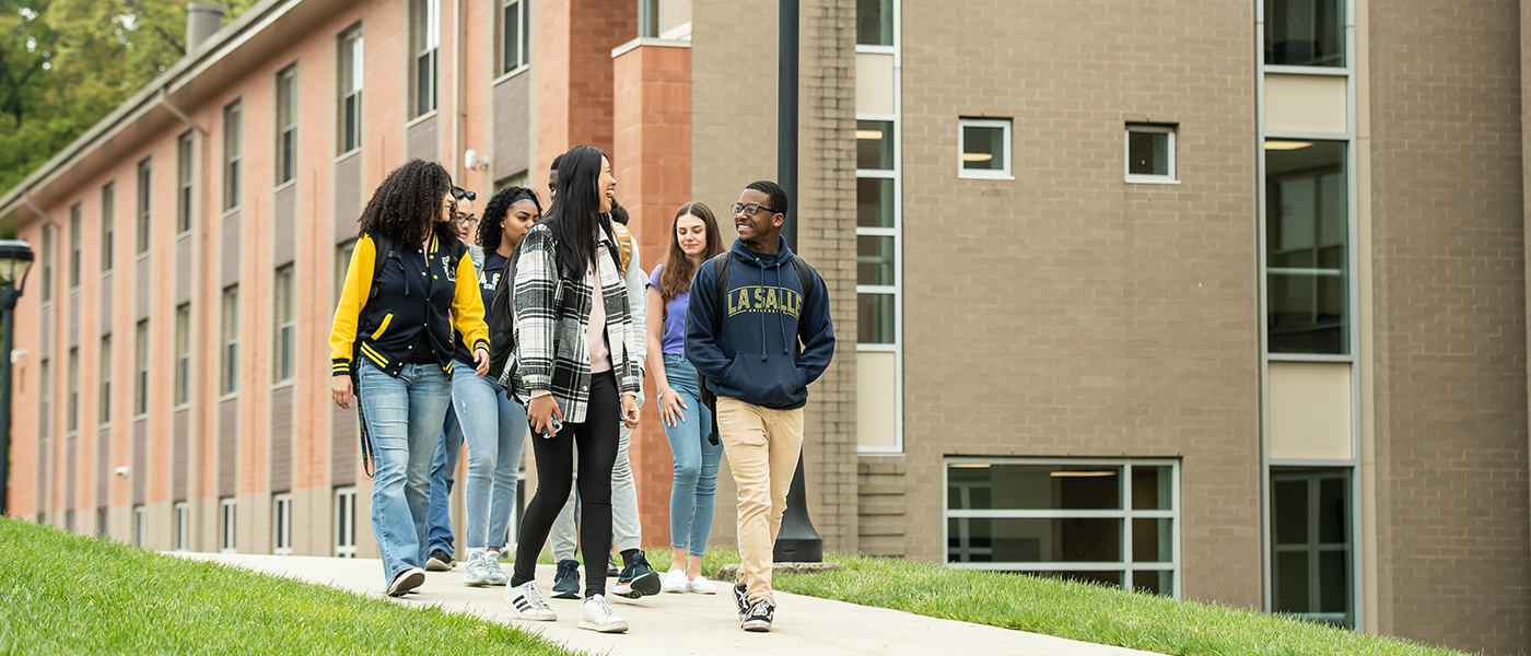 Students walking in front of dorm buildings.