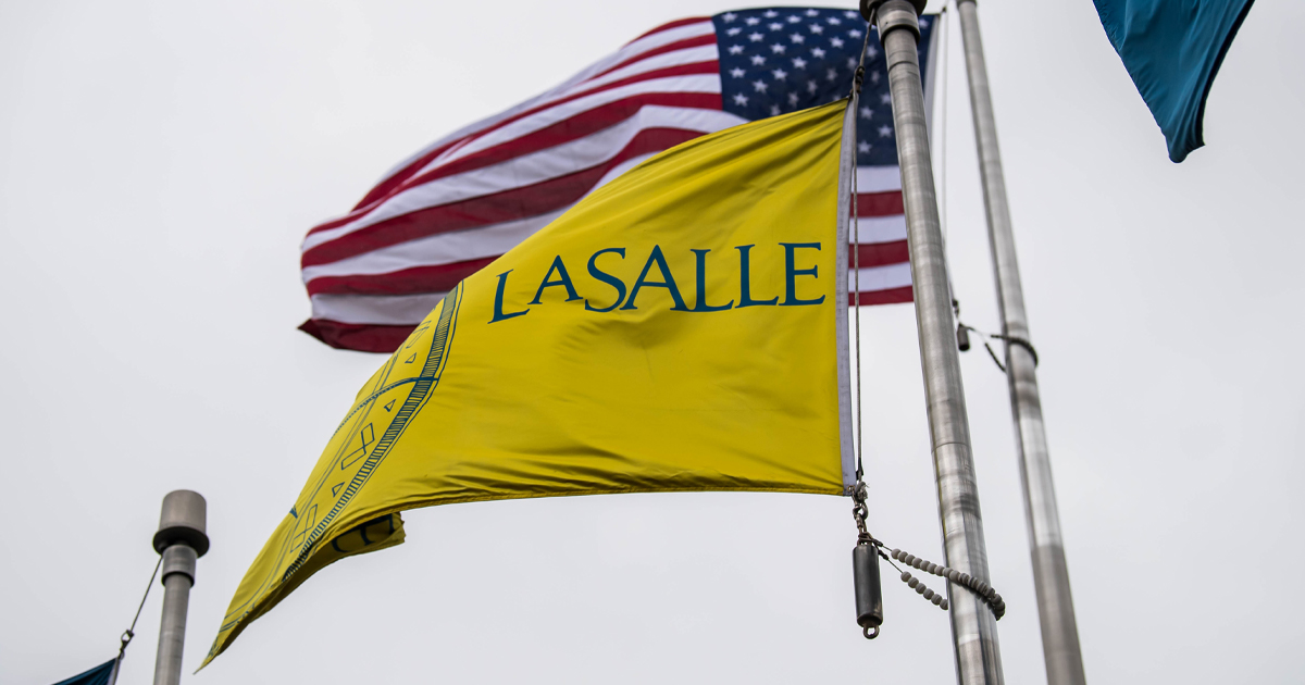 Image of the La Salle University and American flags blowing in the wind.