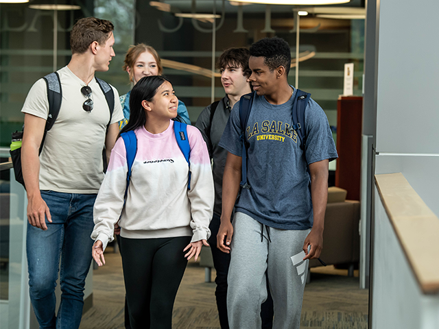 Image of a group of people walking down a hallway