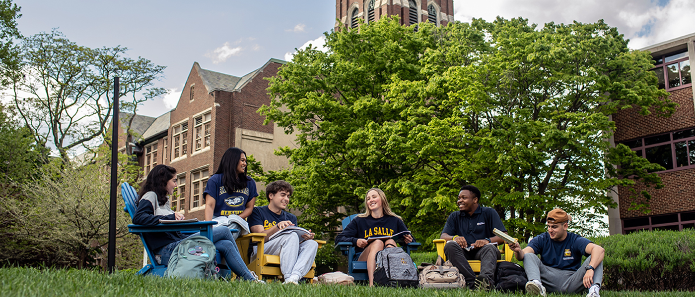 Image of students sitting outside.
