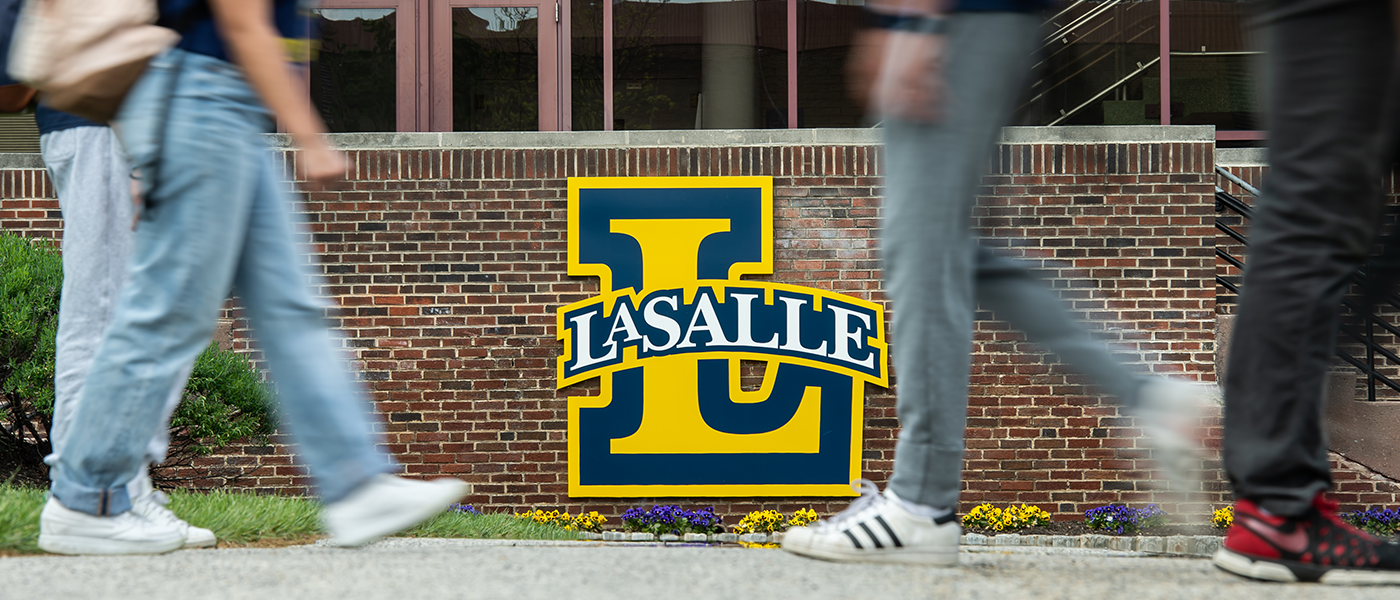 Image of students walking in front of the La Salle "L."