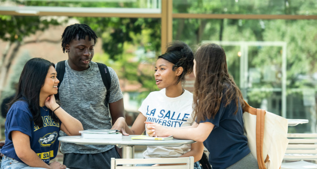Students talking and sitting on campus