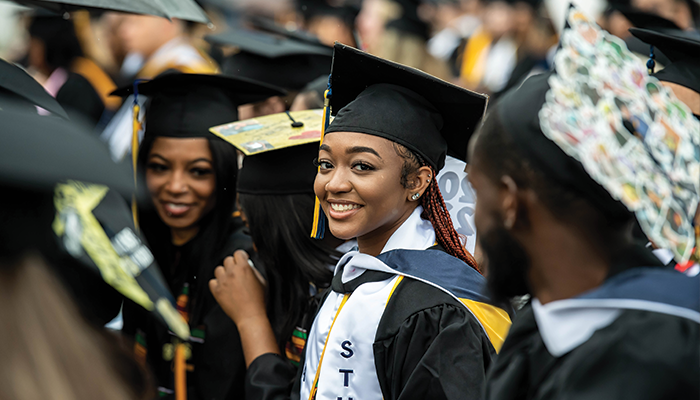 Image of a female student smiling at the camera during Commencement