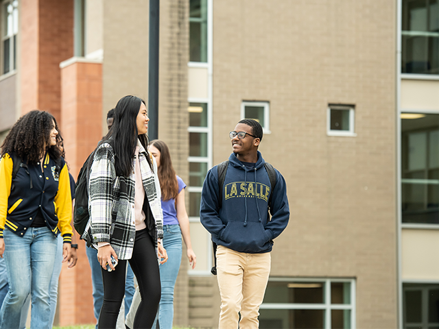 Image of students walking across campus.