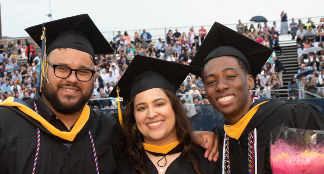 Image of three graduating students.