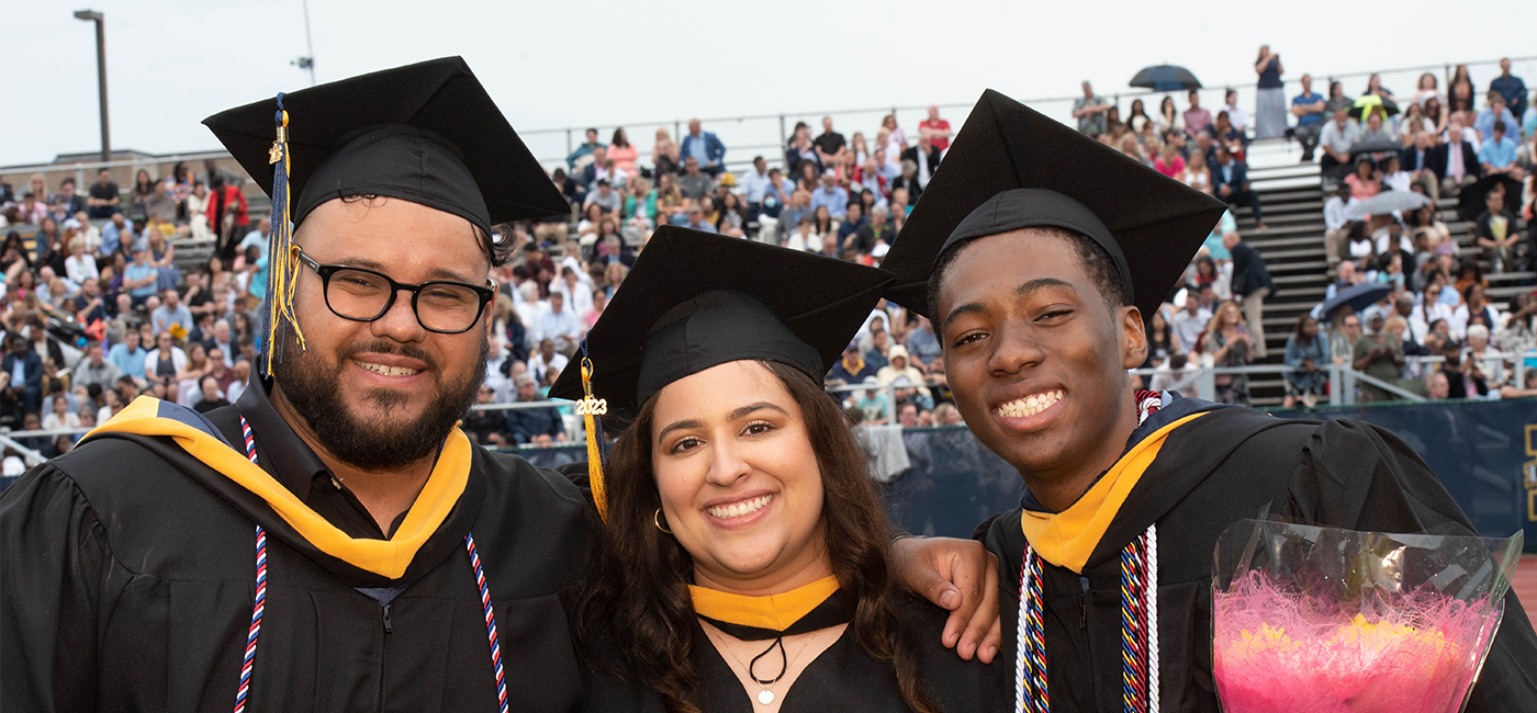 Image of three graduating students.