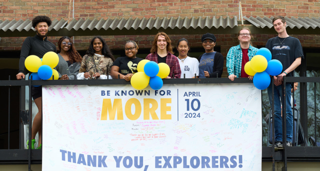 Image of a group of students posing with a Thank you sign.