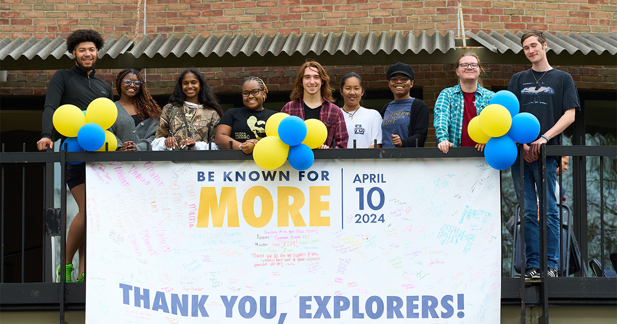 Image of a group of students posing with a Thank you sign.