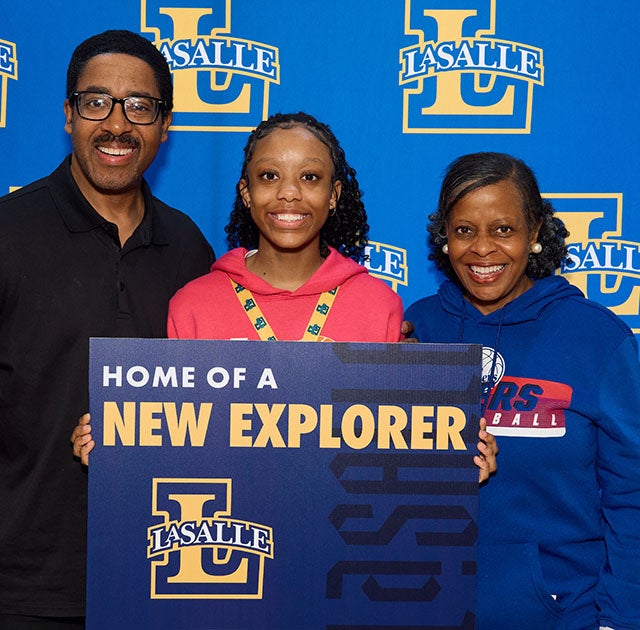 Charity Sawyer, '29, (center) with her parents at La Salle's Blue and Gold Day.