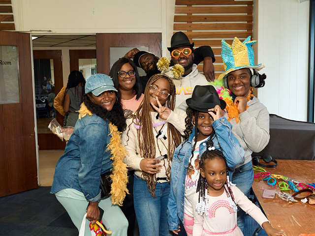 Image of a family wearing photobooth accessories