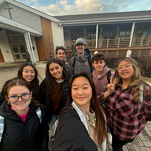 Image of students taking a selfie outside Anselm Hall