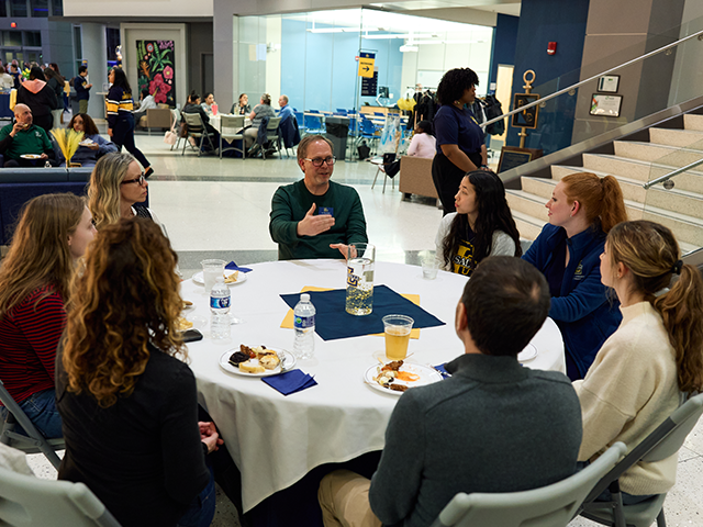 Image of students and faculty chatting