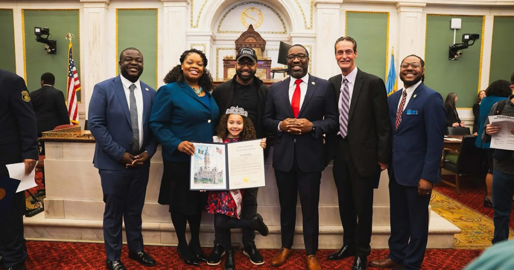 Brandon Washington, '10, (second from left) with his daughter at the National American Miss Pageant.