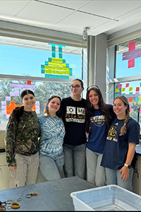 Giovanna Lorenzo, '27 (second from left) in the lab at La Salle University.