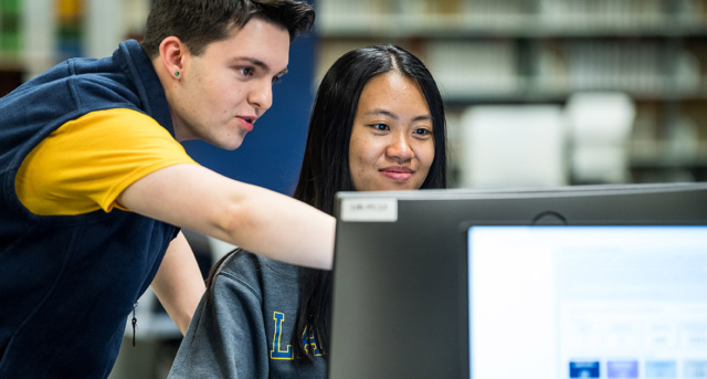 Two students looking at a computer