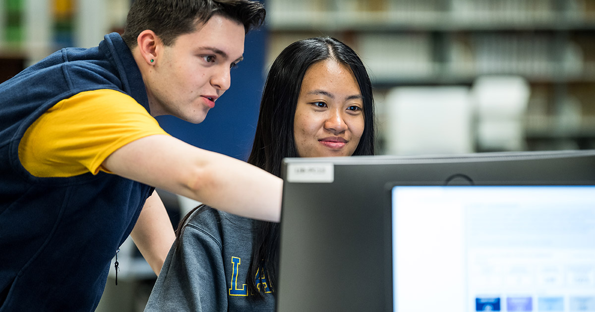 Two students looking at a computer