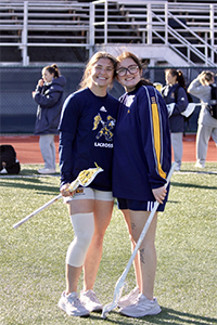 Emily Sarkissian, '26, (right) at a women's lacrosse game.