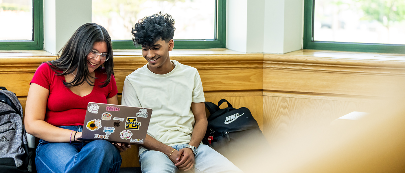 Students looking at a laptop