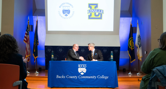 Presidents of Bucks and La Salle shake hands