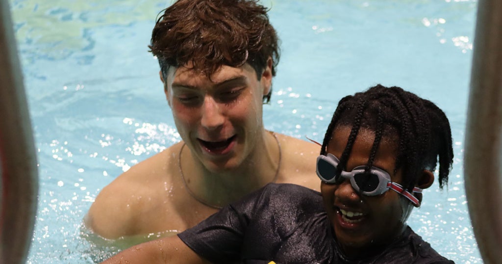James Logan Elementary School second graders with Explorer student-athletes during the Learn to Swim Pilot Program.