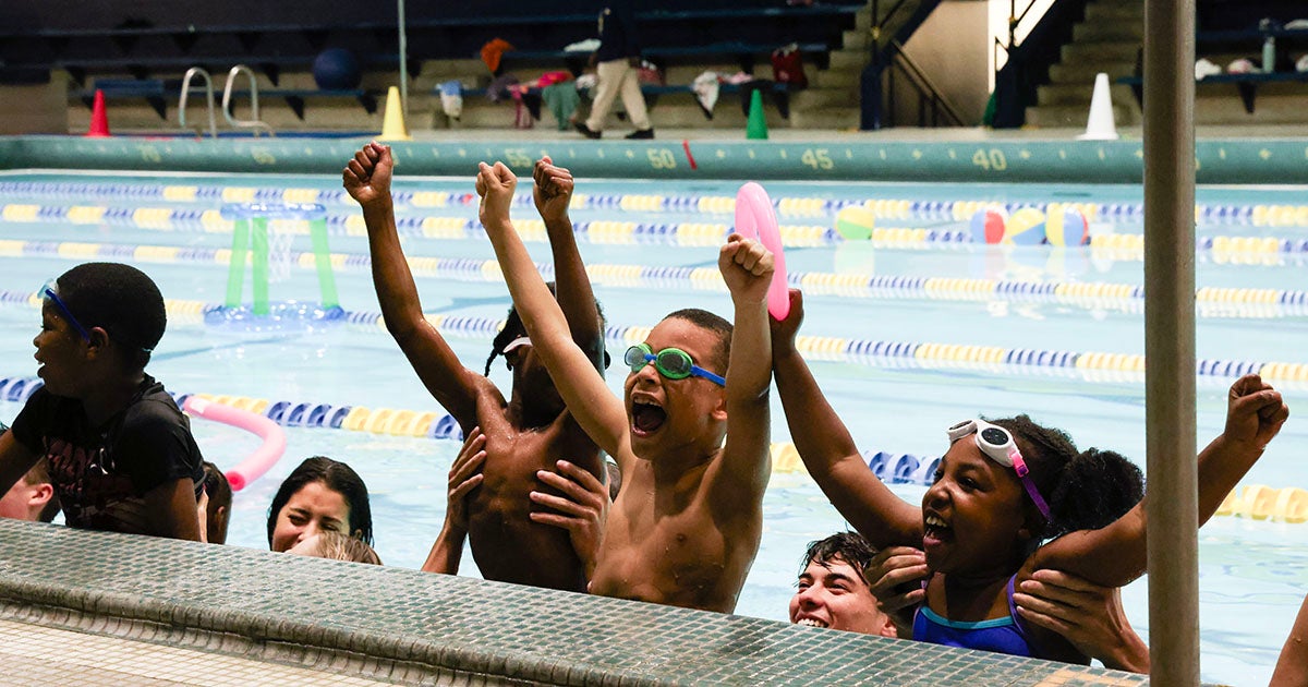 James Logan Elementary School second graders with Explorer student-athletes during the Learn to Swim Pilot Program.