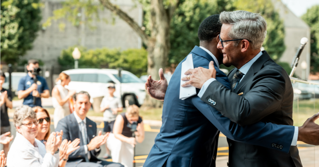 Jarett Gerald and President Allen hug