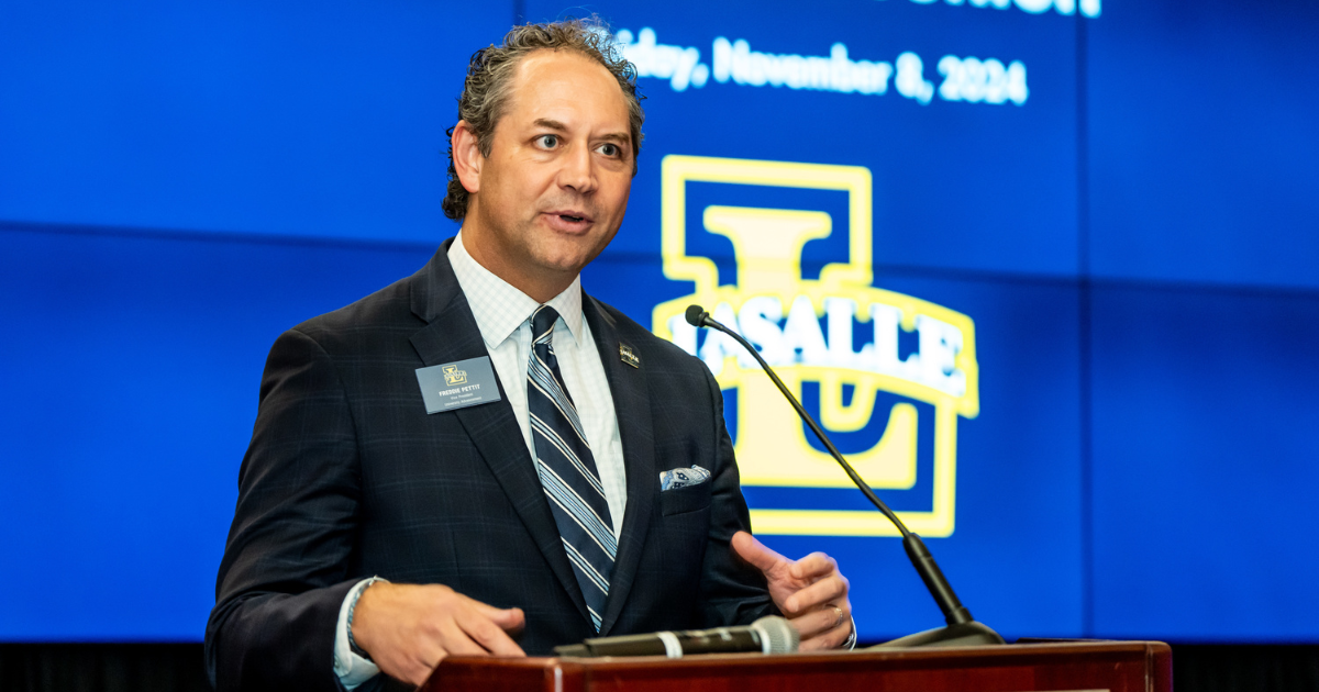 Freddie speaking at a podium