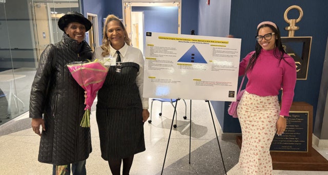 Stacey Chandler, MSW '26 (center) at her capstone project presentation with her mother, Lorna Kaplan, '06, and her daughter, Lorna Chandler, '24.