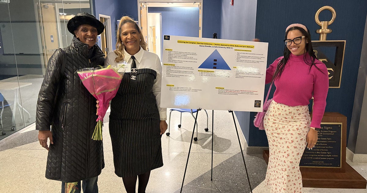 Stacey Chandler, MSW '26 (center) at her capstone project presentation with her mother, Lorna Kaplan, '06, and her daughter, Lorna Chandler, '24.