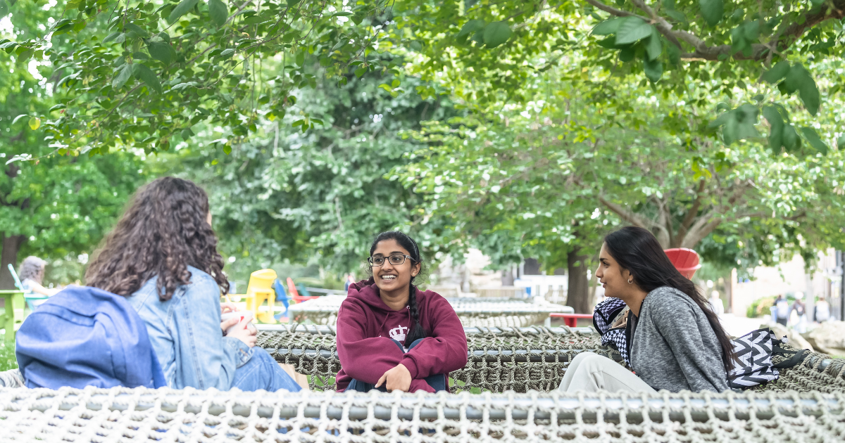 Students in a hammock talking