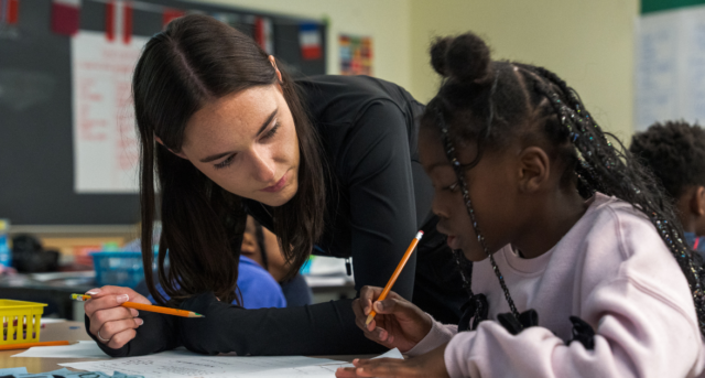 Graduate student helping camper