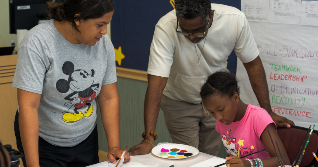 Graduate students helping campers