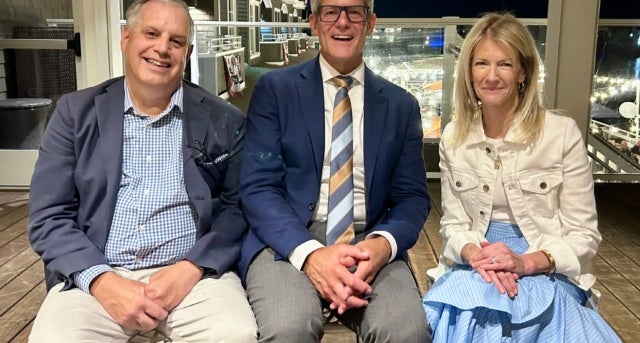 Three people sitting for photo