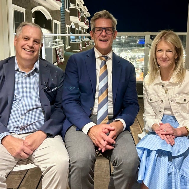 Three people sitting for photo