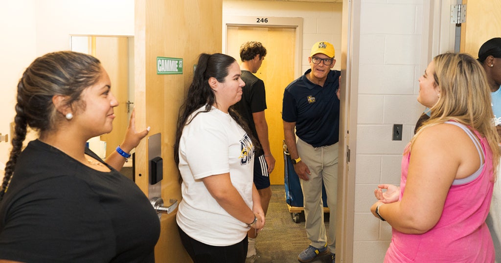 University President Daniel J. Allen, Ph.D., meeting new students, including Cameron Wilson, '30, (left) and Maddie Gallagher, '30, (right) during Move-In Day.