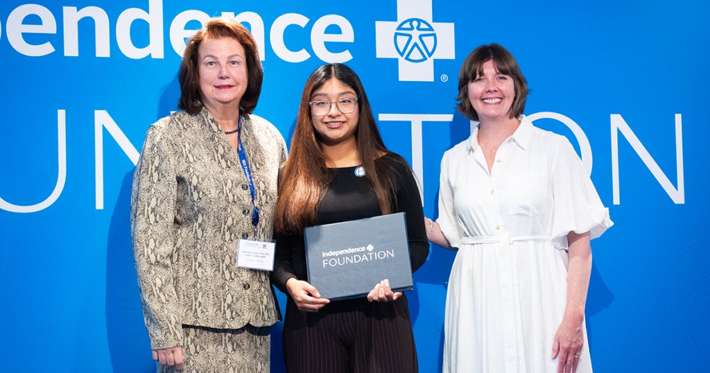 (from left) Beth Ann Swan, dean of La Salle's School of Nursing and Health Sciences, Yulisa Jimenez Lorenzo, '27, and a representative from the IBX Foundation.