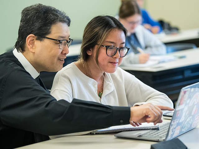 Image of a professor helping a student