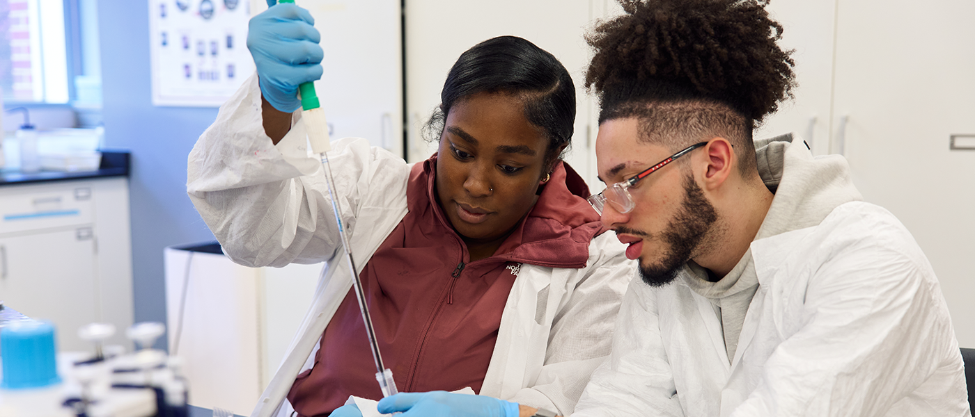 Image of two students working in a science lab