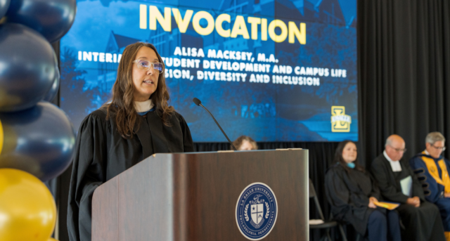 Alisa speaking at podium