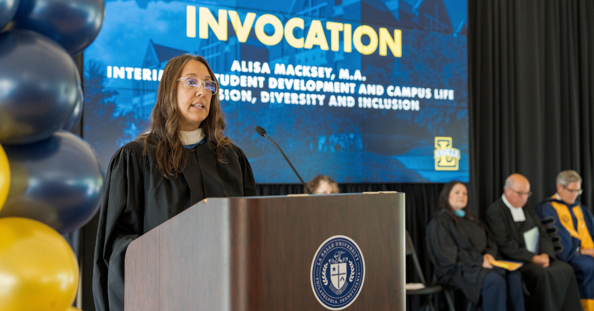 Alisa speaking at podium