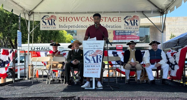Dezlen Long, '27, speaking at the Philadelphia Continental Chapter of the Sones of the American Revolution stage at Independence Mall during the America250 July Fourth celebrations.