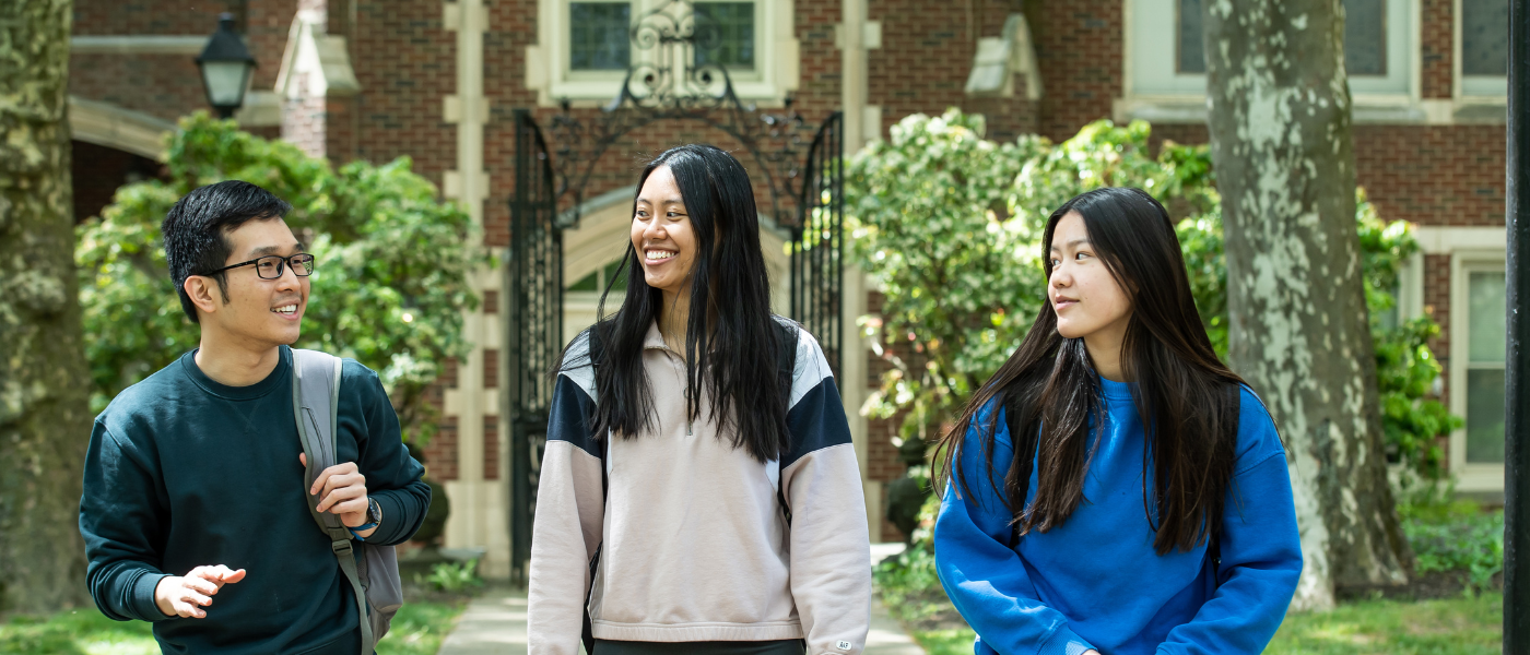 Three students walking on the Hansen Quad